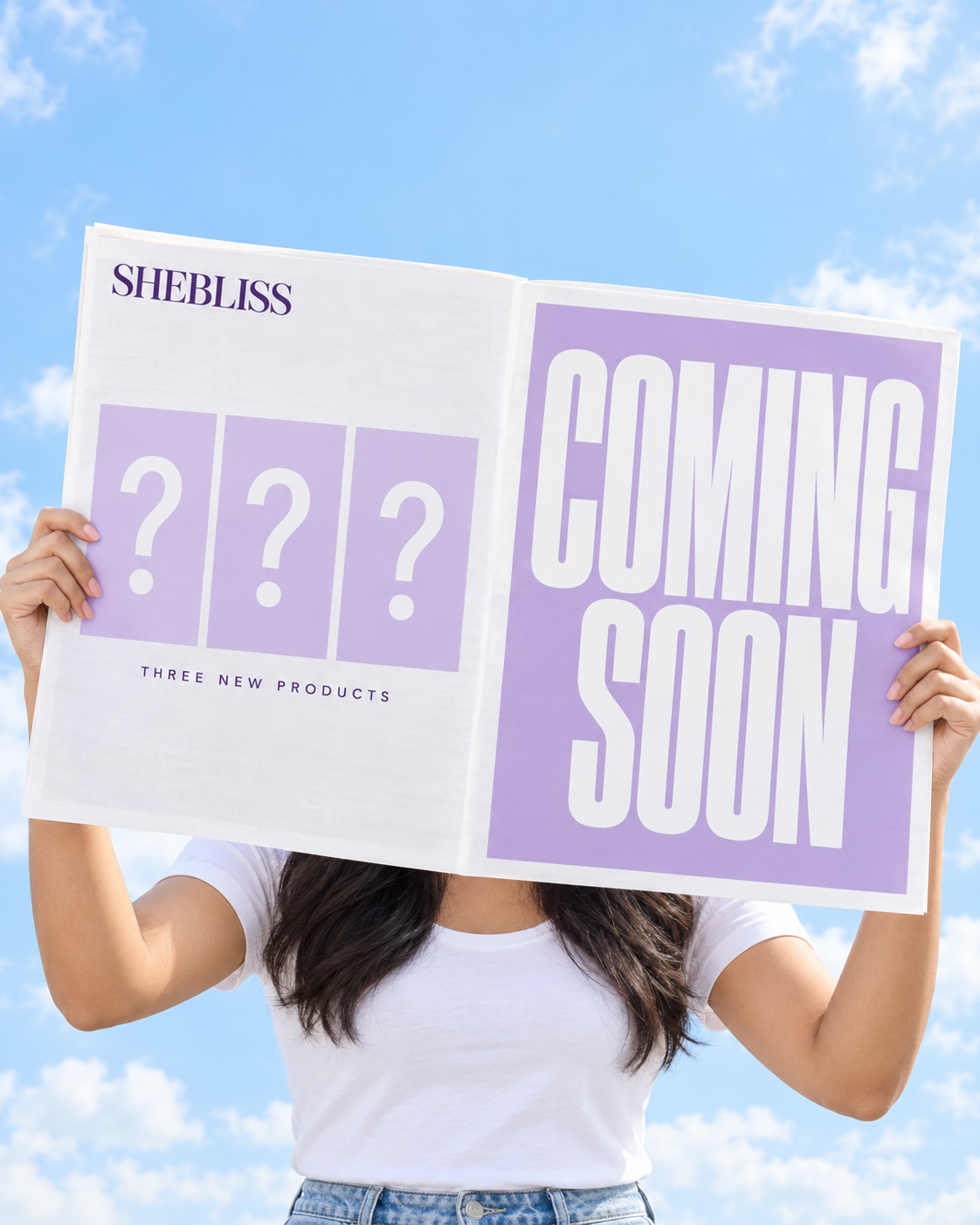 SheBliss coming-soon newspaper in white and lilac against a blue sky